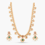 A picture of an Indian artificial necklace set in gold tone, featuring mango-shaped pearls and green teardrop beads with earrings.