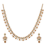 A picture of an Indian artificial gold necklace set with green gemstones and Cubic Zirconia on a white background.
