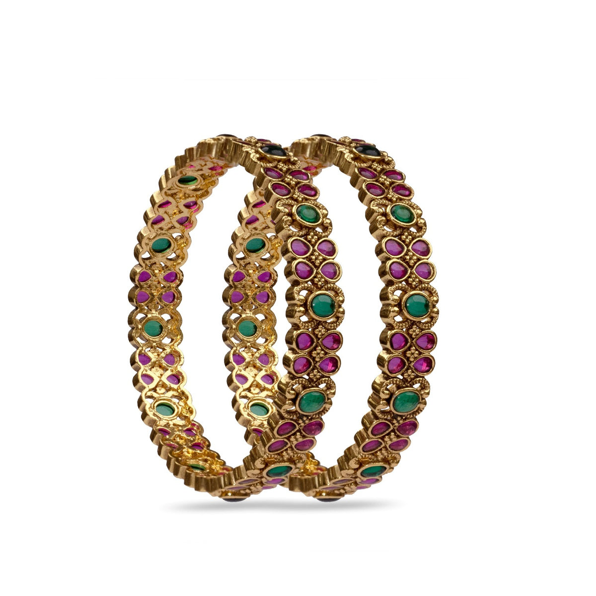 A close up image of a gold plated bracelet with green and red gemstones.