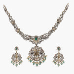 A picture of an Indian artificial gold plated necklace set with floral designs,Cubic Zirconia and red gemstones , and pearl embellishments.
