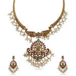 An image of a temple necklace set, featuring goddess Laxmi idols, adorned with white beads and red - green gemstones.