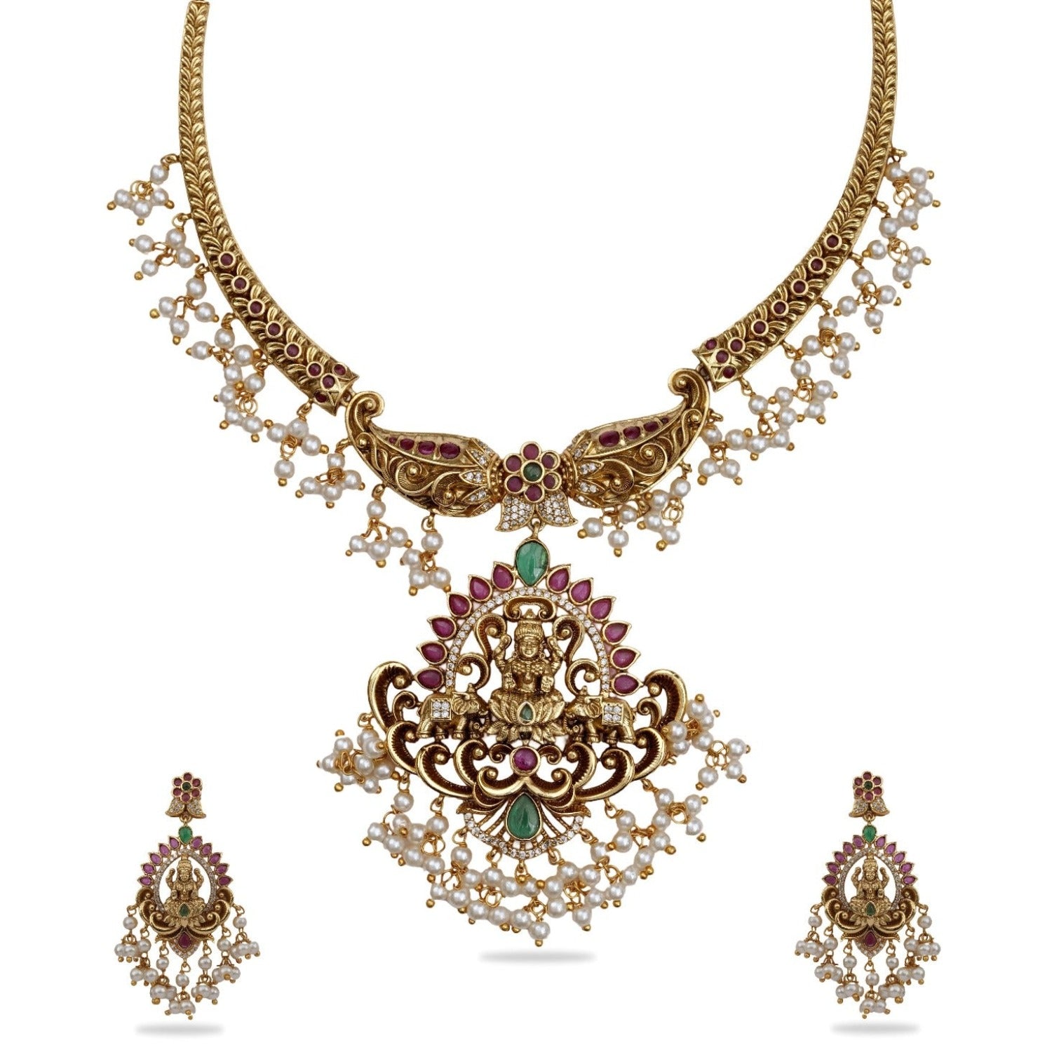 An image of a temple necklace set, featuring goddess Laxmi idols, adorned with white beads and red - green gemstones.