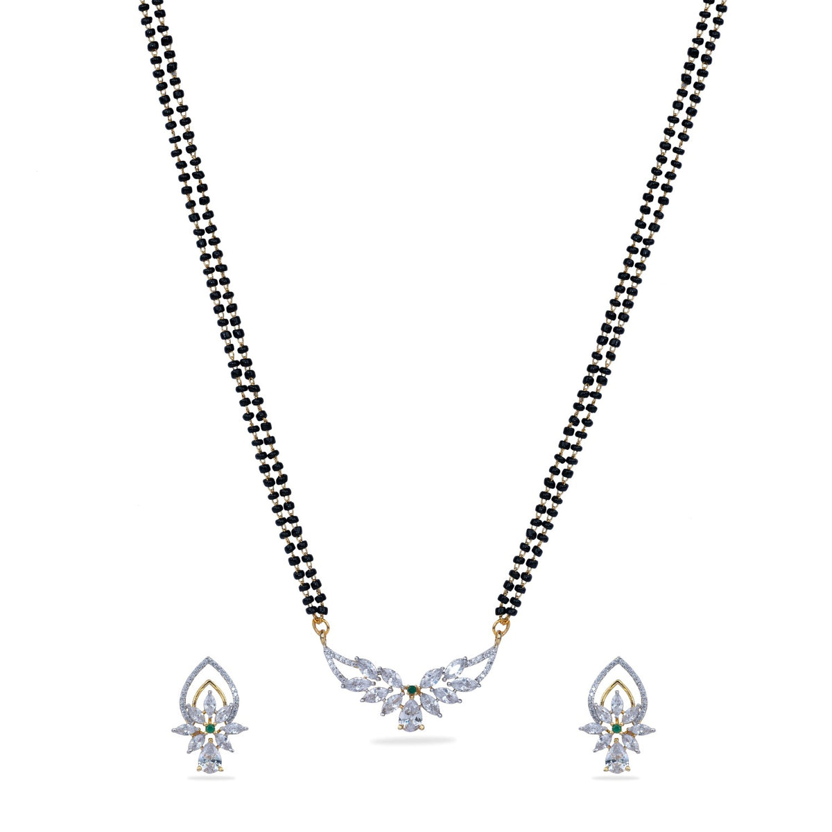 A close up picture of a necklace set, featuring white, black and green beads with a pendant.