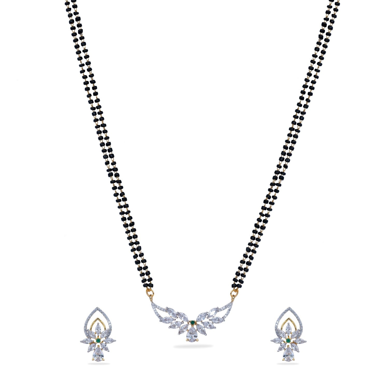 A close up picture of a necklace set, featuring white, black and green beads with a pendant.