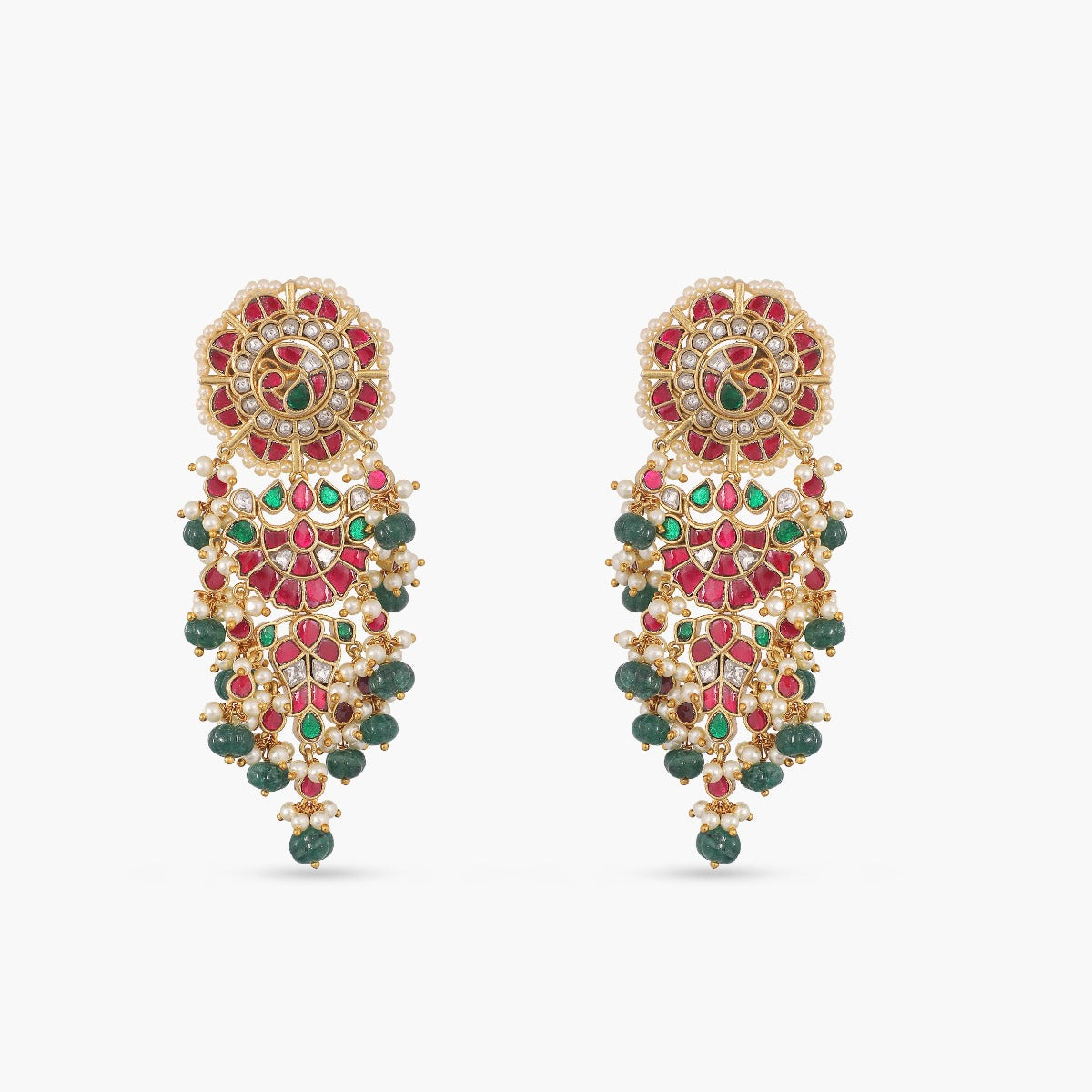 A picture of an Indian artificial gold plated necklace set with floral designs, red and green gemstones, and pearl embellishments in jadau style.