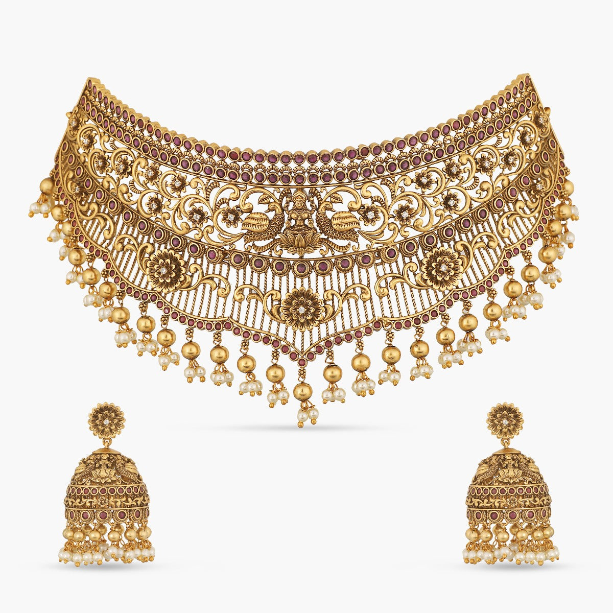 A picture of an Indian antique gold plated necklace set with a Lakshmi idol in the centre and matching earrings.
