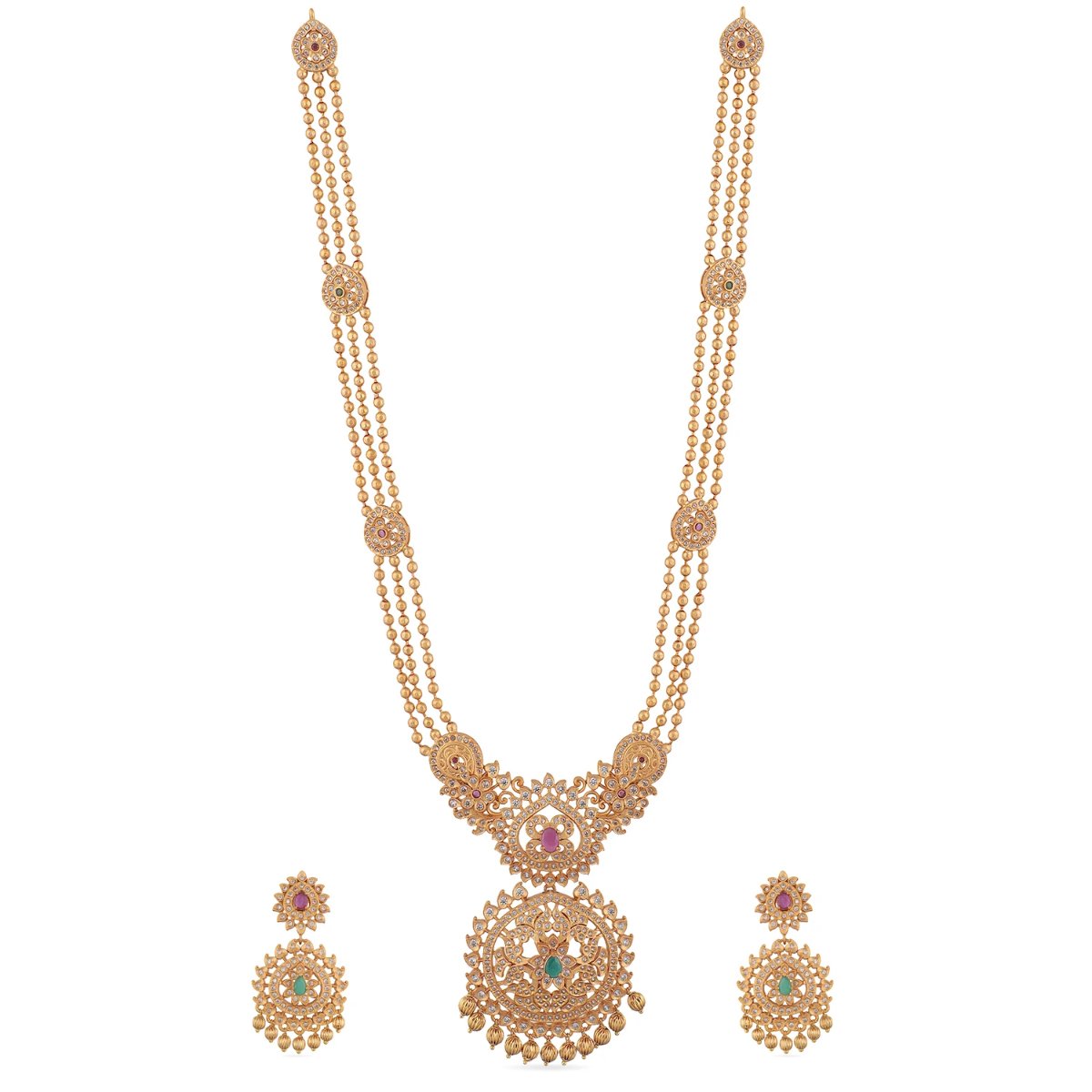 A picture of an Indian artificial necklace set with a gold-toned chain, a floral pendant with green gemstones, and matching earrings.