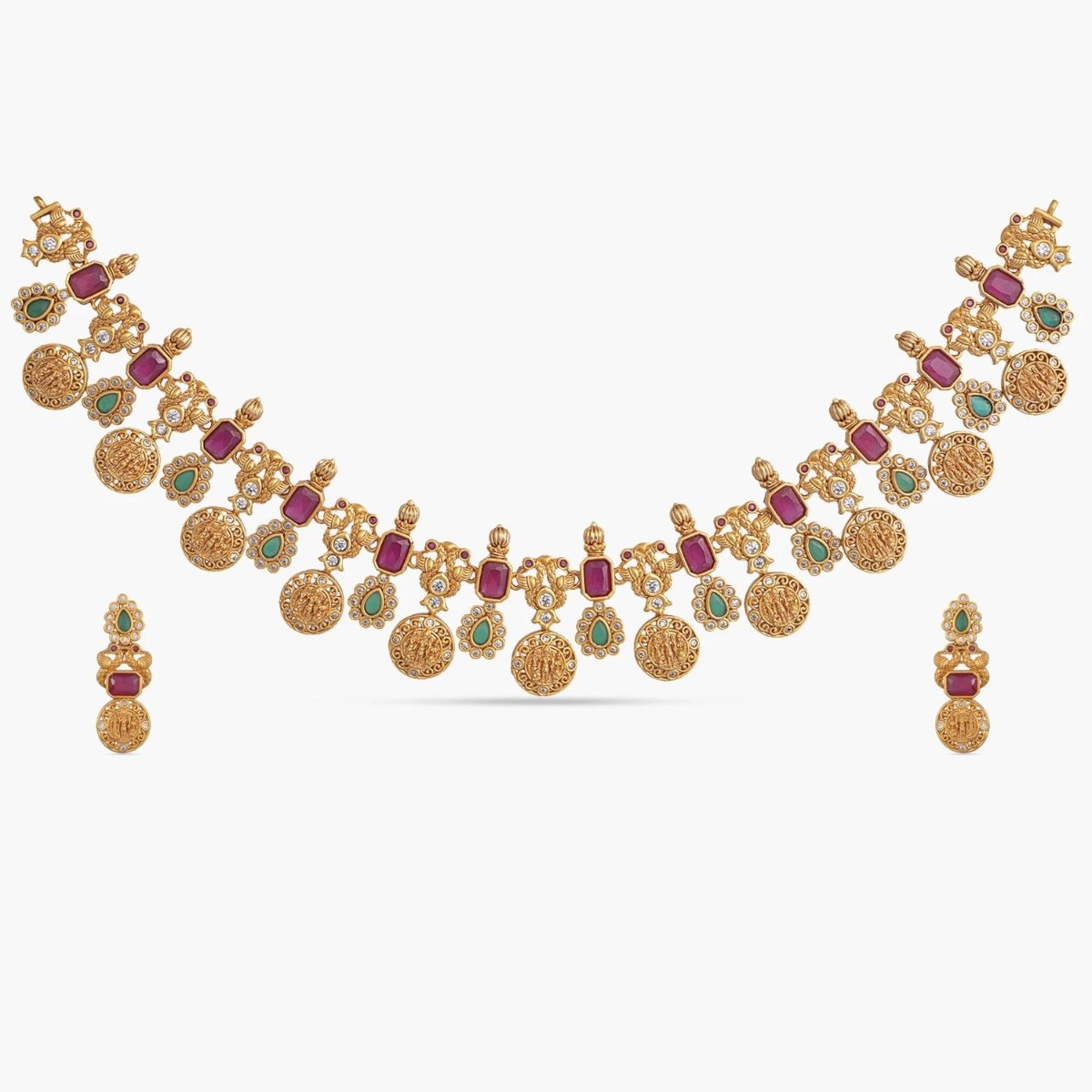 A picture of an Indian artificial necklace and earring set. The set is gold-toned with floral designs and green gemstones.
