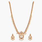 A picture of an Indian artificial gold plated necklace set with a pendant in the shape of a dome and peacock designs.
