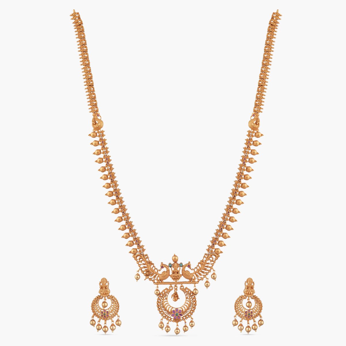 A picture of an Indian artificial gold plated necklace set with a pendant in the shape of a dome and peacock designs.