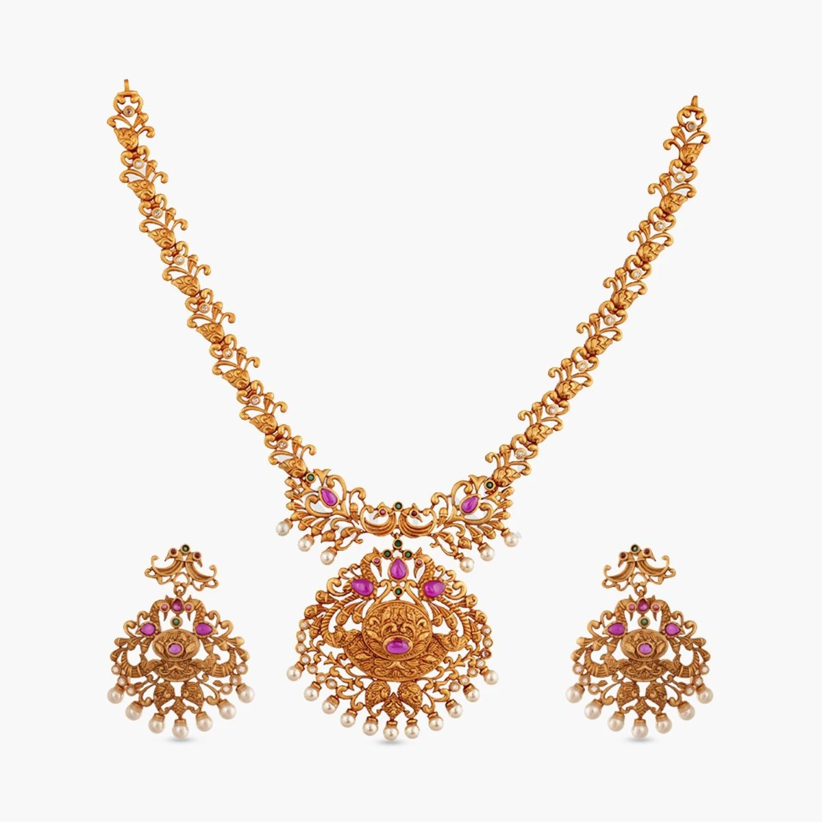 A picture of an Indian artificial gold plated necklace set with peacock motof pendant in red gemstones and pearls, with matching earrings.