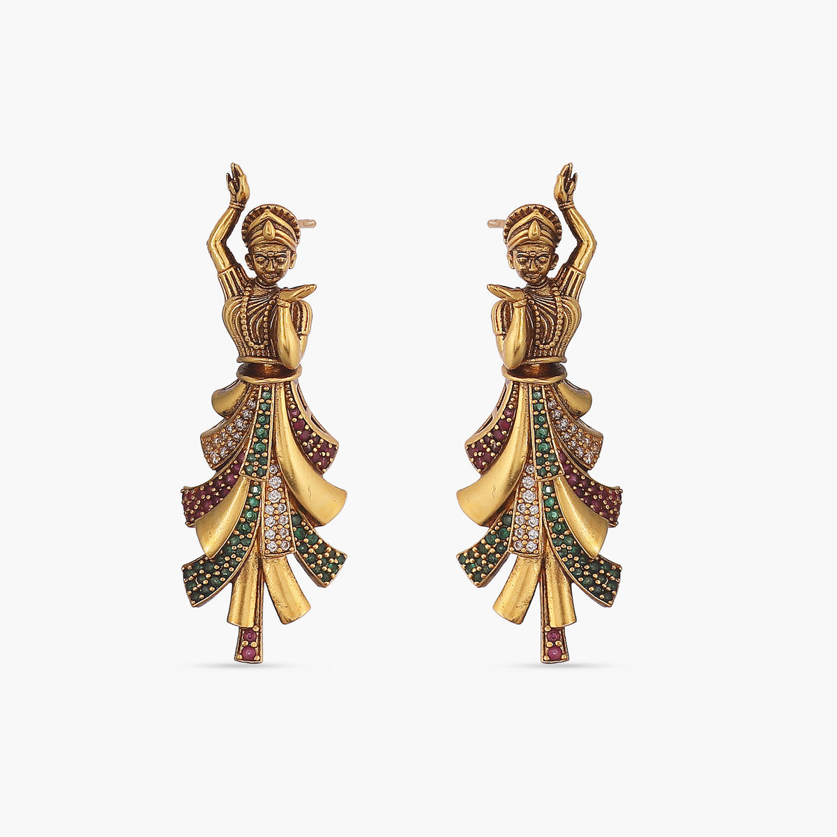 A picture of a pair of Indian artificial gold plated earrings with a dancing lady motif in a circular design and green gemstones.