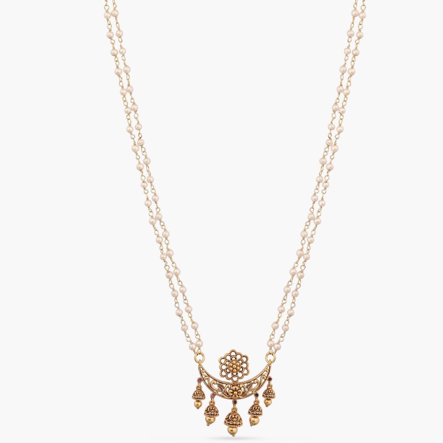 A picture of an Indian artificial gold plated necklace set with a pendant in moon shaped pedant and antique balls.