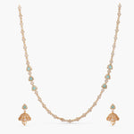 A picture of an Indian artificial gold plated necklace with Cubic Zirconia and green gemstones.