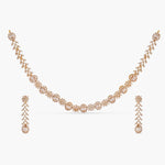 A picture of an Indian artificial necklace and earring set, featuring red and clear Cubic Zirconia stones and gold-colored embellishments.