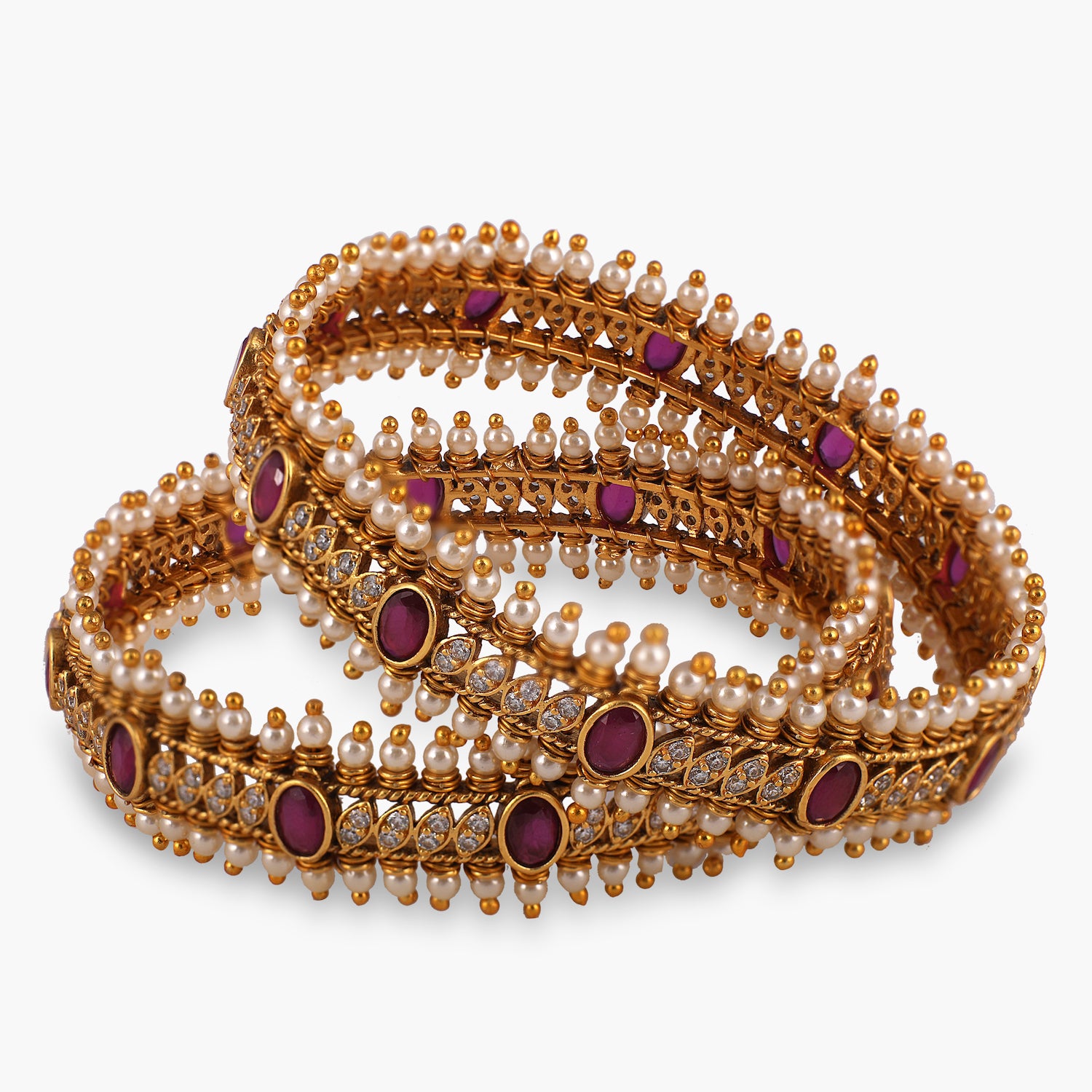 A picture of a pair of Indian gold plated bangles set with colorful rhinestones, Cubic Zirconia and  pearls.