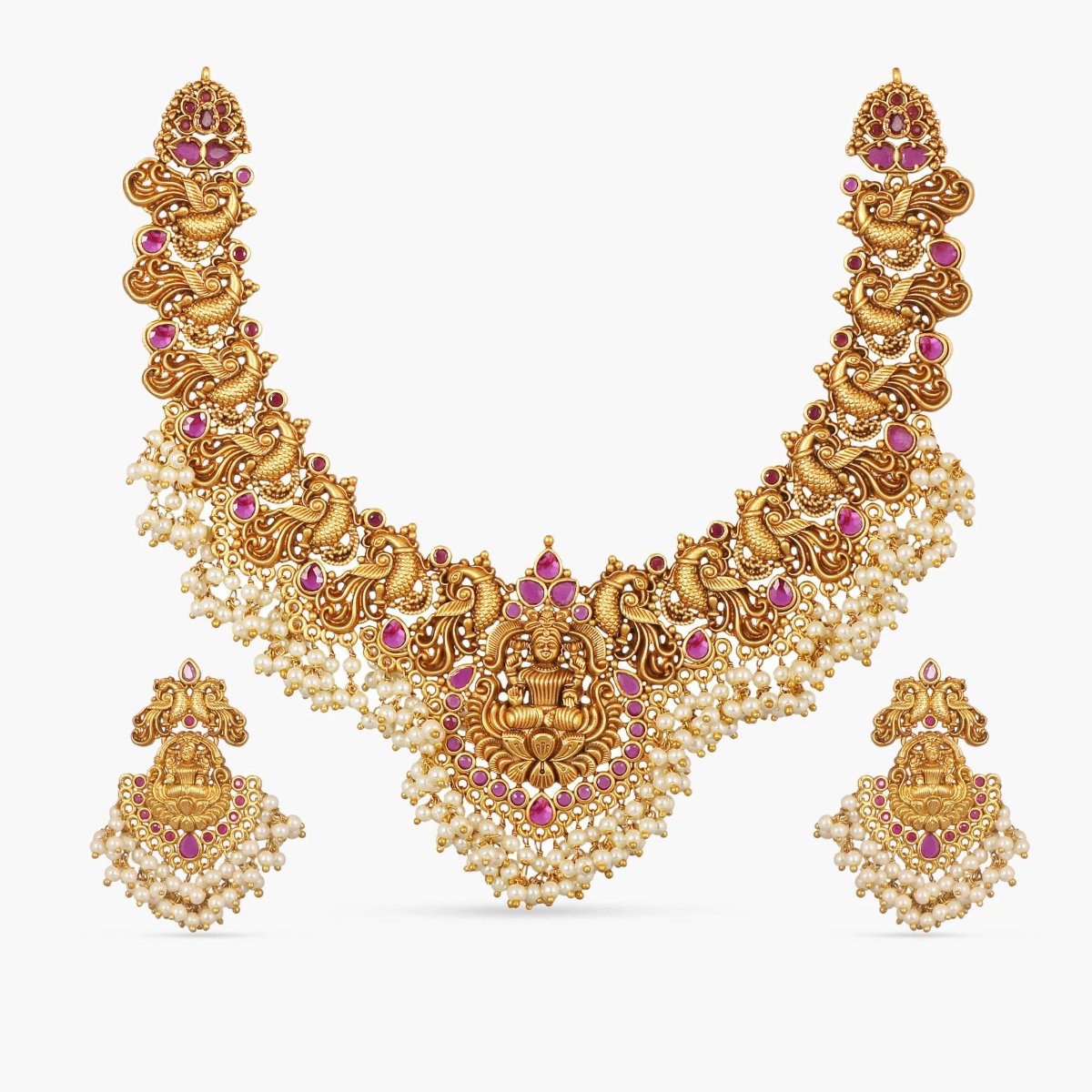 A picture of an Indian artificial gold necklace and earring set. The necklace is embellished with pearls and the earrings are chandelier style.