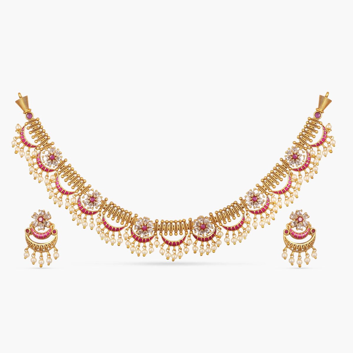 A picture of an Indian artificial gold plated necklace set with floral designs,Cubic Zirconia and red gemstones , and pearl embellishments.